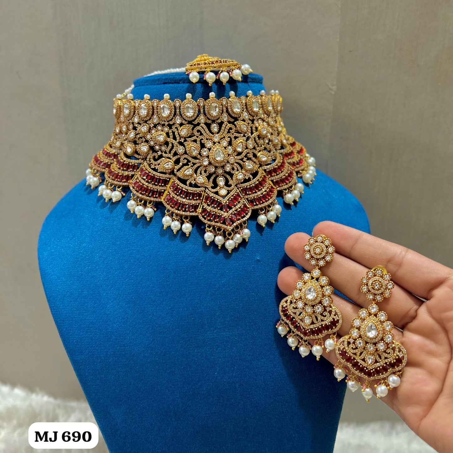 the Zevar Kundan & Pearl Choker Necklace Set Maroon Royal Kundan Emerald Ruby Pearl Bridal Choker Necklace Set with Earrings and Maang Tikka