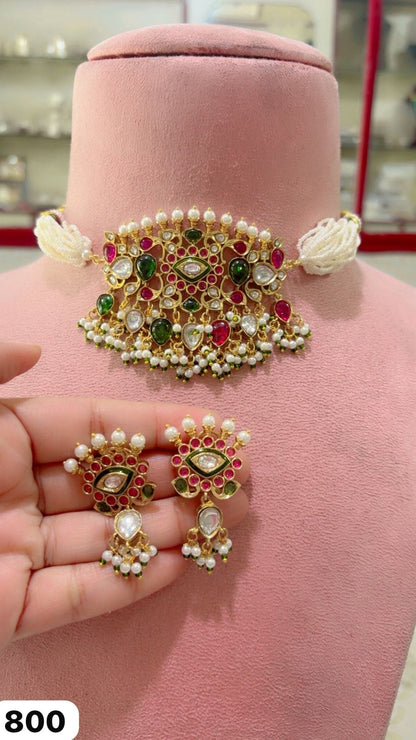 the Zevar choker necklace Exquisite Jadau Kundan Choker Set with Multi-Strand Pearl Band, Ruby-Emerald Accents, and Matching Drop Earrings