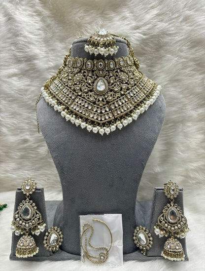 the Zevar Kundan Bridal Jewelry Set White Regal Emerald Green Handcrafted Kundan Bridal Jewellery Set with Mathapatti & Nath